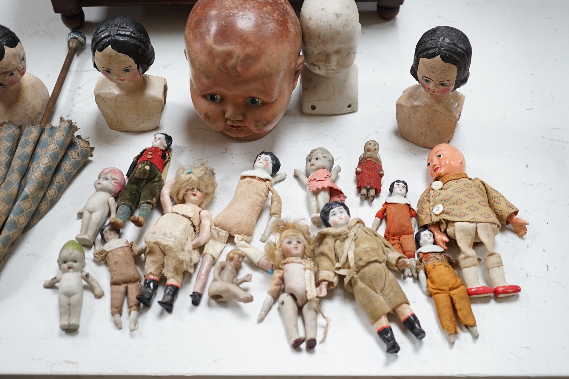 Two Kammer and Reinhardt bisque headed dolls, a wax over composition doll, various other bisque headed dolls and a few single heads and a collection of miniature dolls